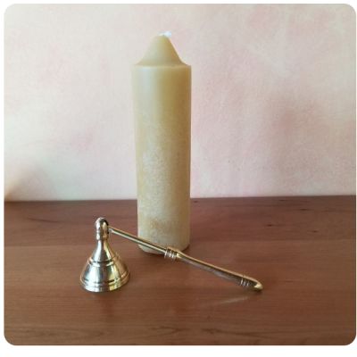 Small candle snuff with brass finish.